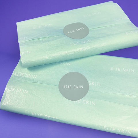 Image of Custom Coloured Tissue Paper wrapping gift with sticker for label