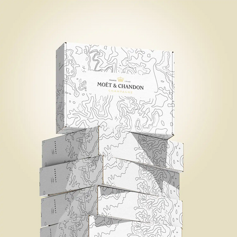 Image of Stack of Moét & Chandon champagne boxes on a beige background