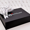 White custom printed tissue paper on top of black gift box | NEON Packaging