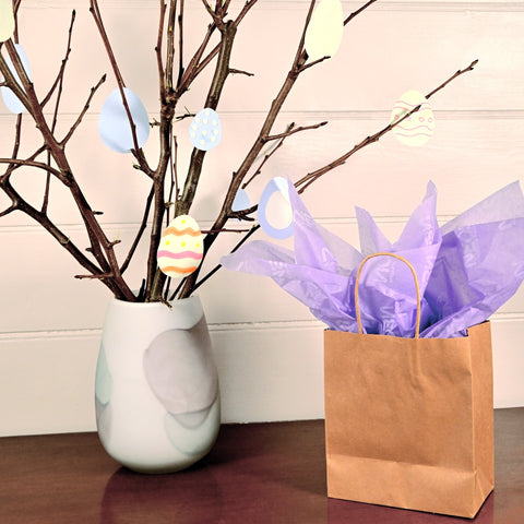 Image of brown kraft paper bags with purple tissue paper